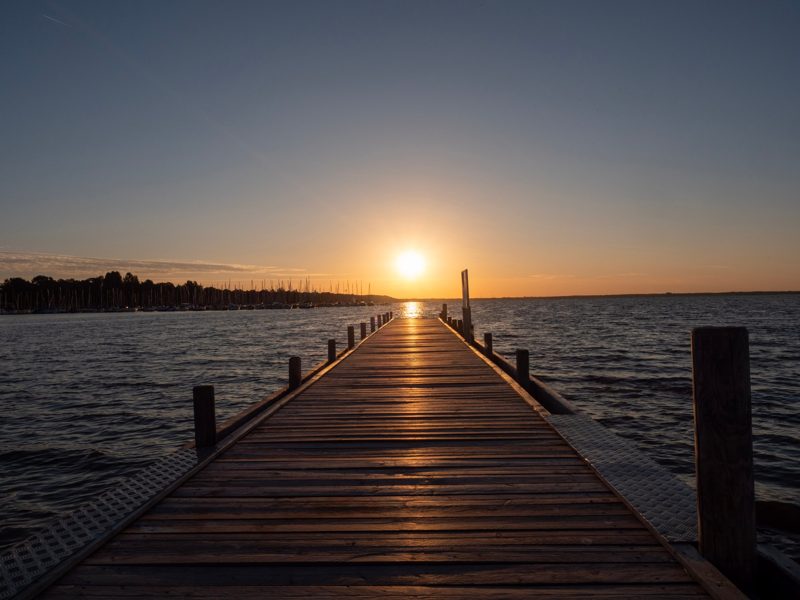 Holzsteg im Sonnenuntergang am See